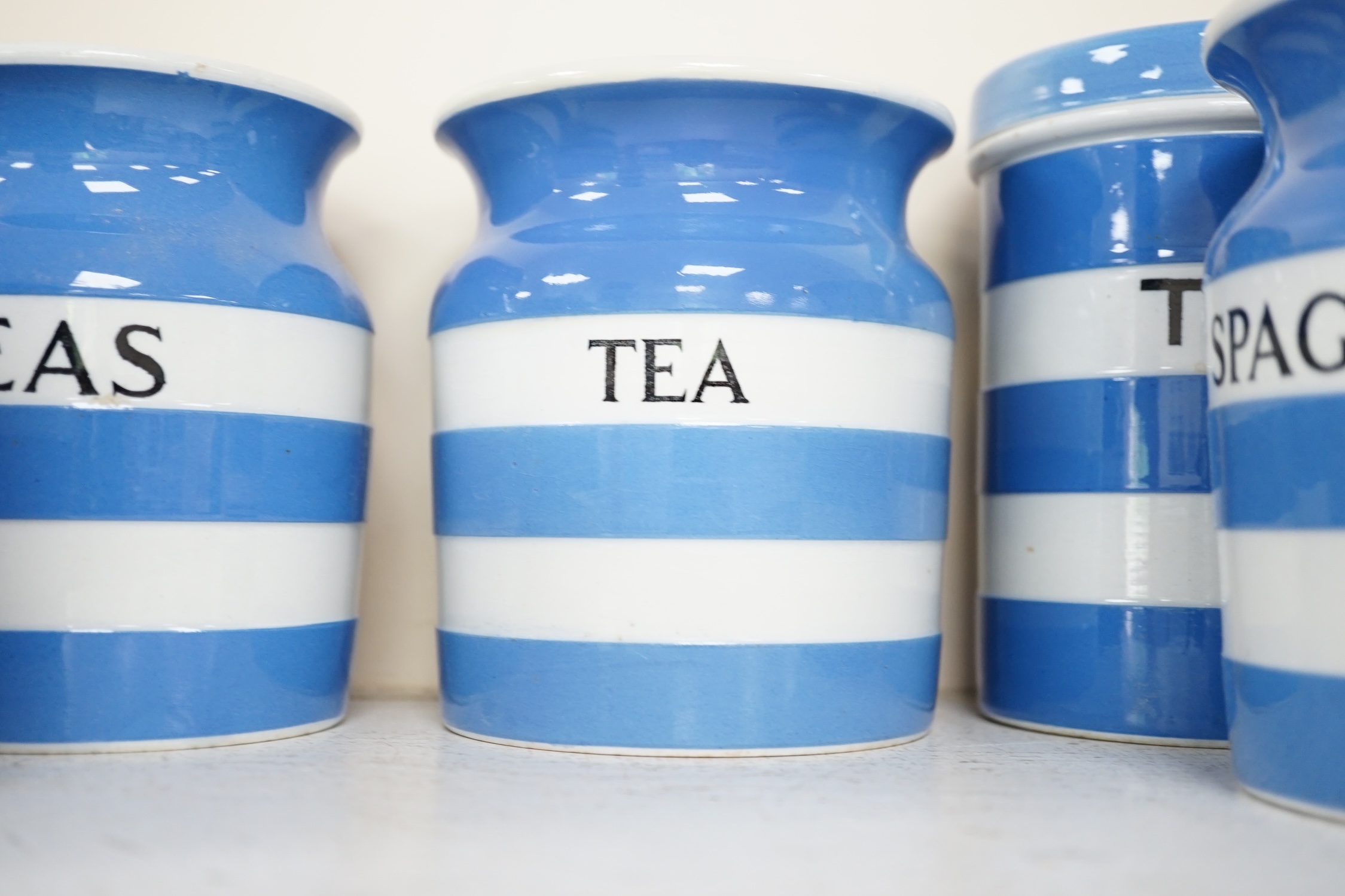 T.G.Green Cornish Kitchenware, fifteen lidded storage jars, to include Moist Sugar, Spaghetti, Semolina, Patna Rice, Brown Rice, Butter and Lard, largest 14cm high, Black Shield marks. Condition - poor, fair and good